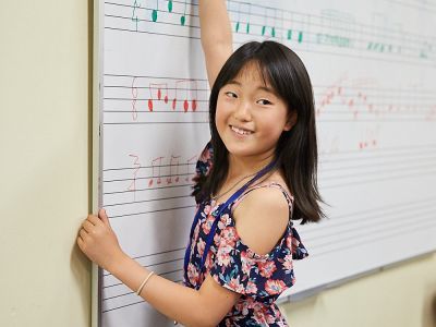 student writing on whiteboard